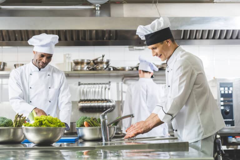 multicultural chefs working at restaurant kitchen