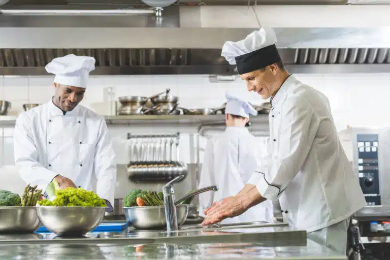 multicultural chefs working at restaurant kitchen