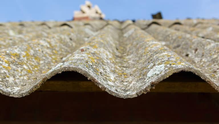 Dangerous asbestos roof. Asbestos dust in the environment. Health problems